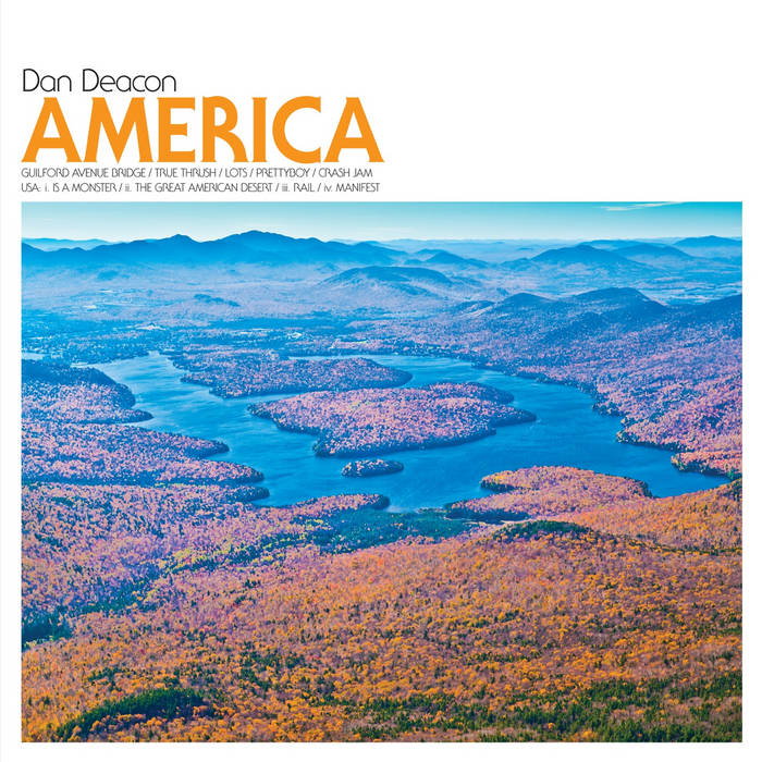 the album art for america by dan deacon, featuring a beautiful photograph of a lake surrounded by flower-covered hills