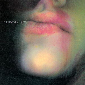 the album art for dry by pj harvey. a green face and unnerving lipstick smeared lips